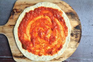 sauced pizza dough, red sauce