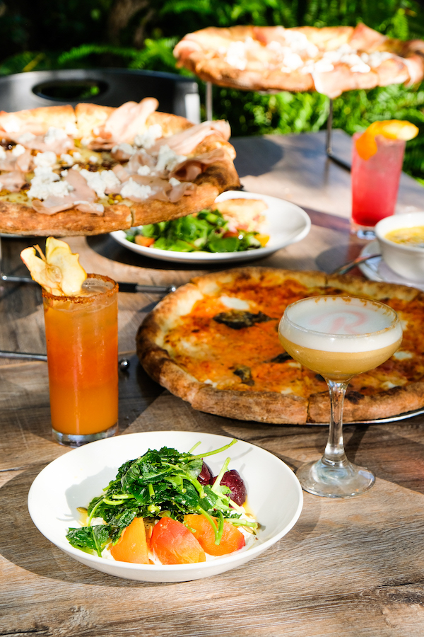 table of pizza, salads, craft cocktails, Robert's Pizza and Dough Company, Chicago Illinois, on the Chicago River