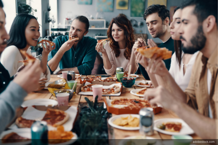 Image of group eating pizza at a restaurant