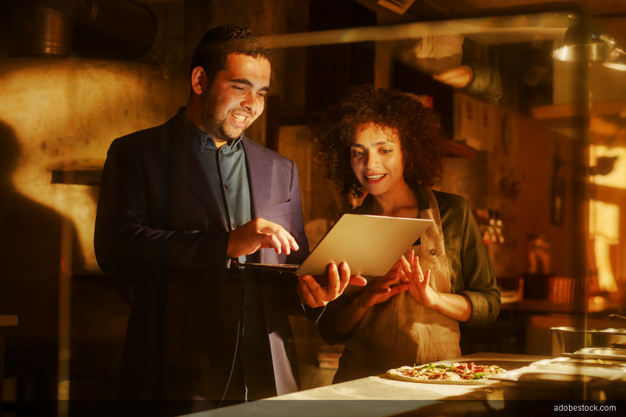 Image of pizzeria workers using computer