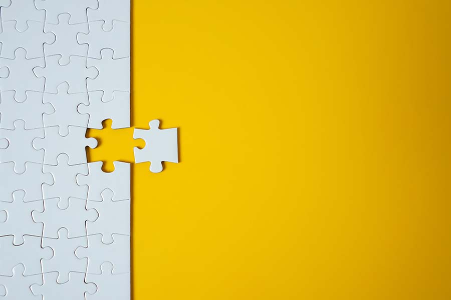 Image of puzzle piece fitting into puzzle.