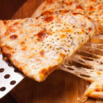 Image of a cheese pizza slice being picked up.