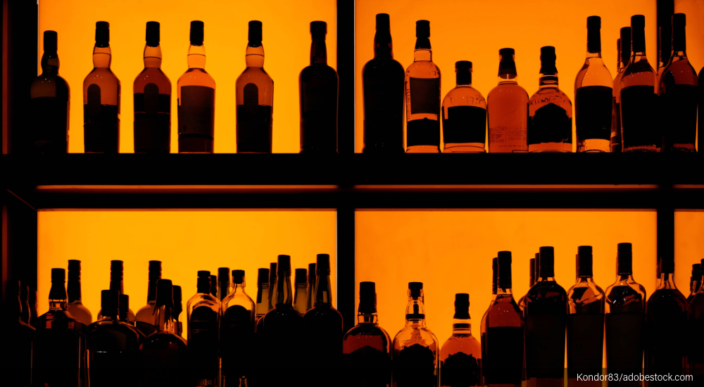 Image of liquor bottles at a bar.