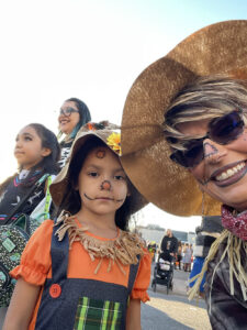 Image of Wholly Stromboli co-founder Melissa Rickman with attendees of the restaurant's annual Halloween block party.