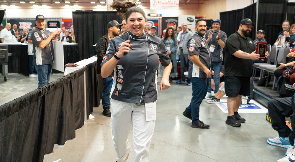 Image of Nicole Bean running to accept first prize at The Great American Pizza Challenge.