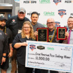 Image of Chris Battiste claiming the "big check" for winning America's Best Pepperoni Slice at Pizza Expo Columbus.