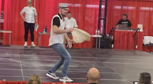 Image of Casey Cole competing during the Acrobatic Dough Tossing event at the World Pizza Games.