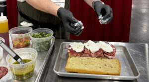 Image of competitor assembling sandwich for the International Italian Sandwich Challenge