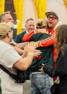 Traditional Pizza Division Champion is Patrice Desmeules embrace teammates after win
