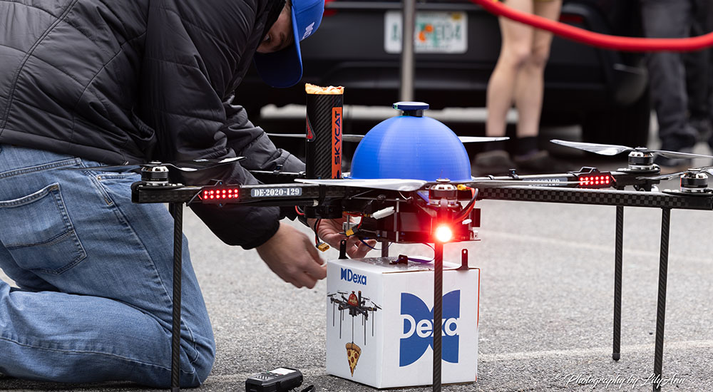 Image of drone being prepared for pizza dewlivery