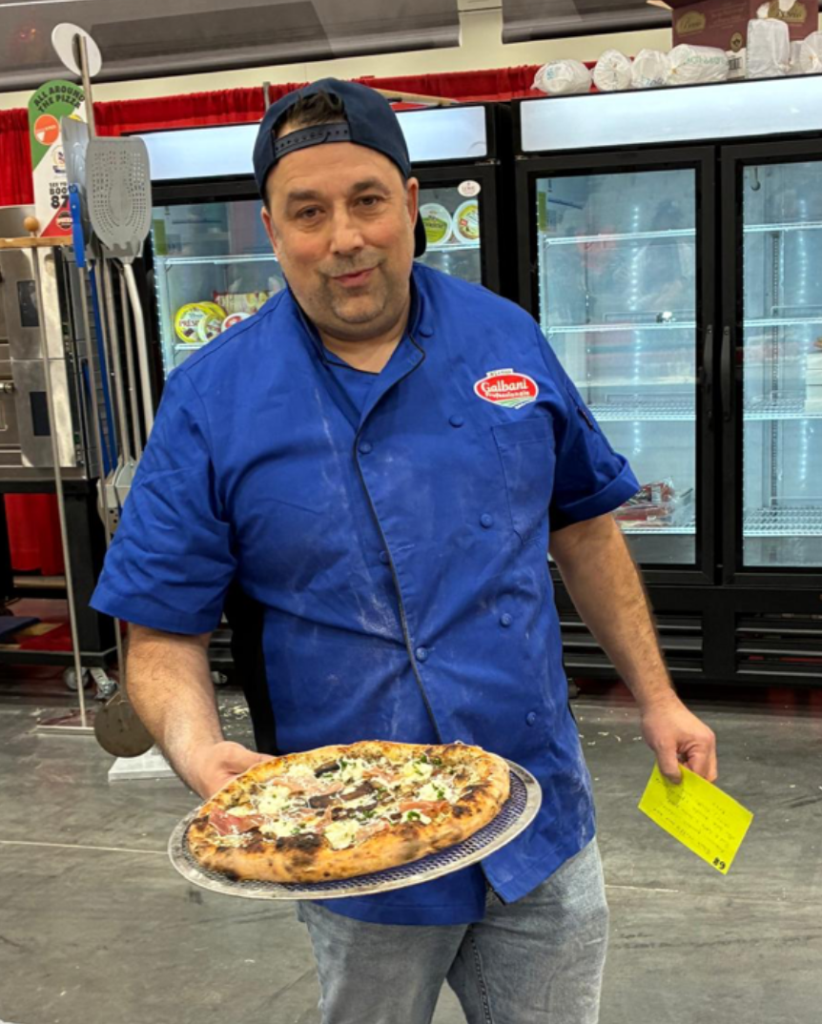 Paulo Guerra of Toronto, Ontario, Canada with his winning Italian Classica Division Pizza at International Pizza Challenge during Pizza Expo in Las Vegas